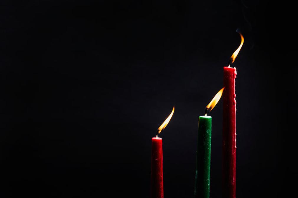 two candles with one lit in the middle and the other two are lit up with a candle - three christmas